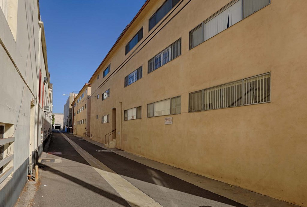 an empty street with a large building on the side