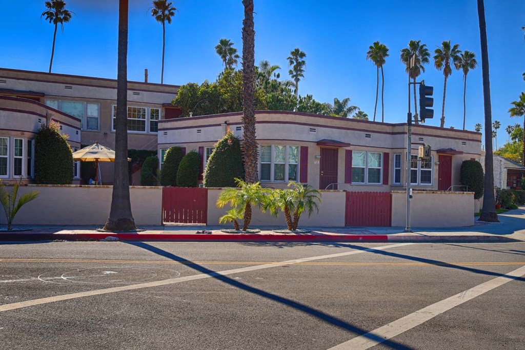 a building on a street with palm trees