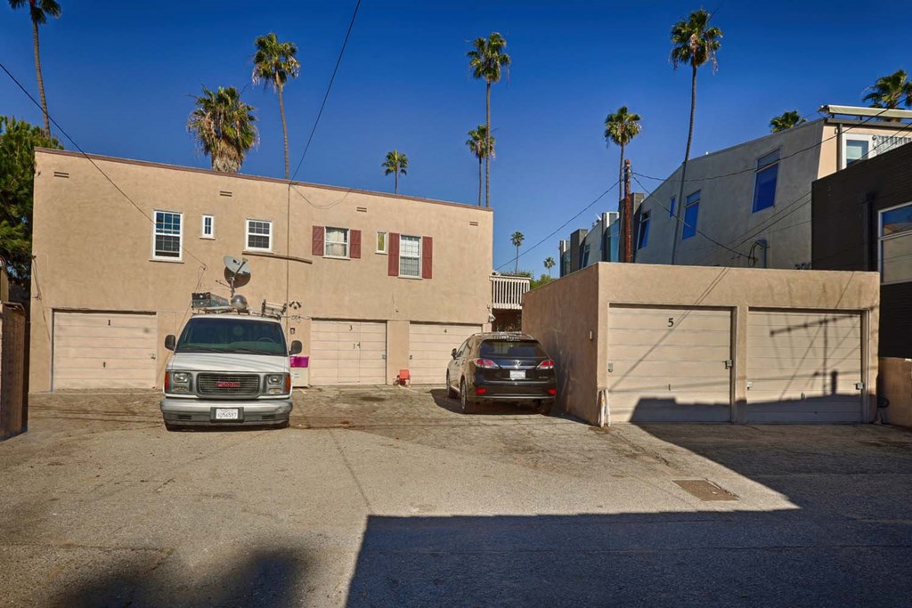 a garage with two cars parked in front of a building