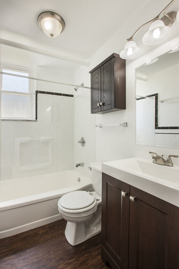 a bathroom with a toilet and a sink and a shower