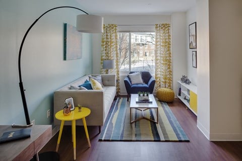 a living room with a couch and a yellow table