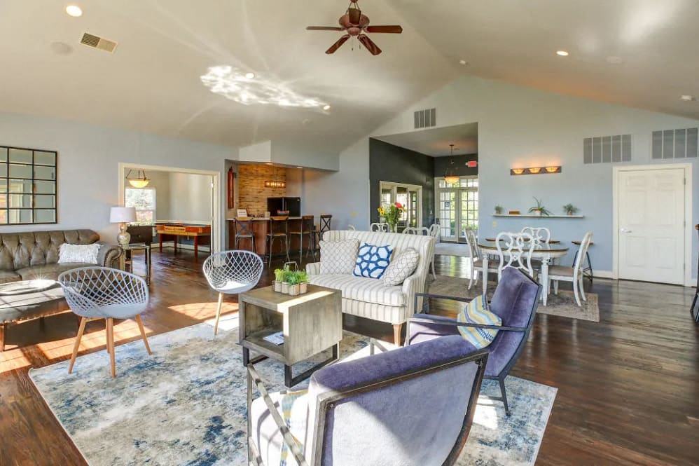 a living room with furniture and a ceiling fan