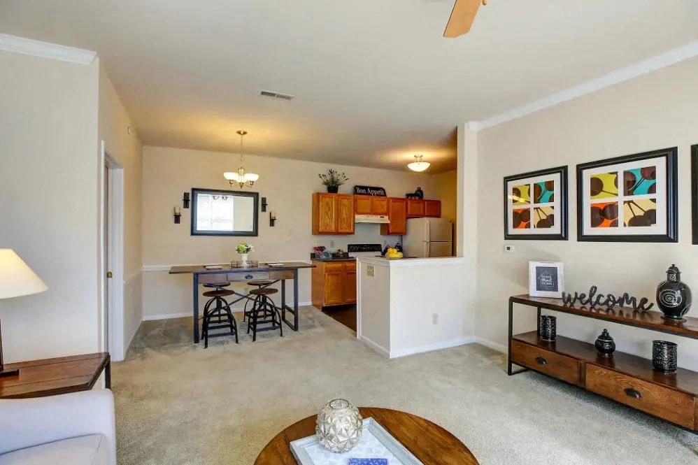 a living room with a kitchen and a table