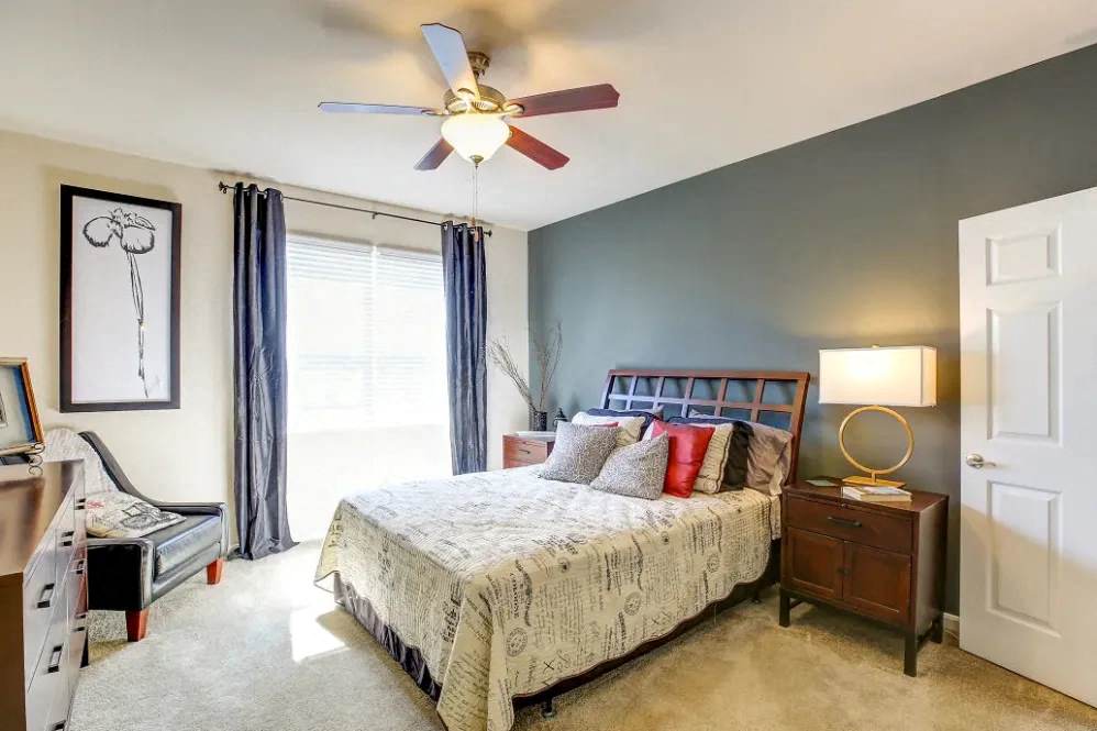 a bedroom with a bed and a ceiling fan