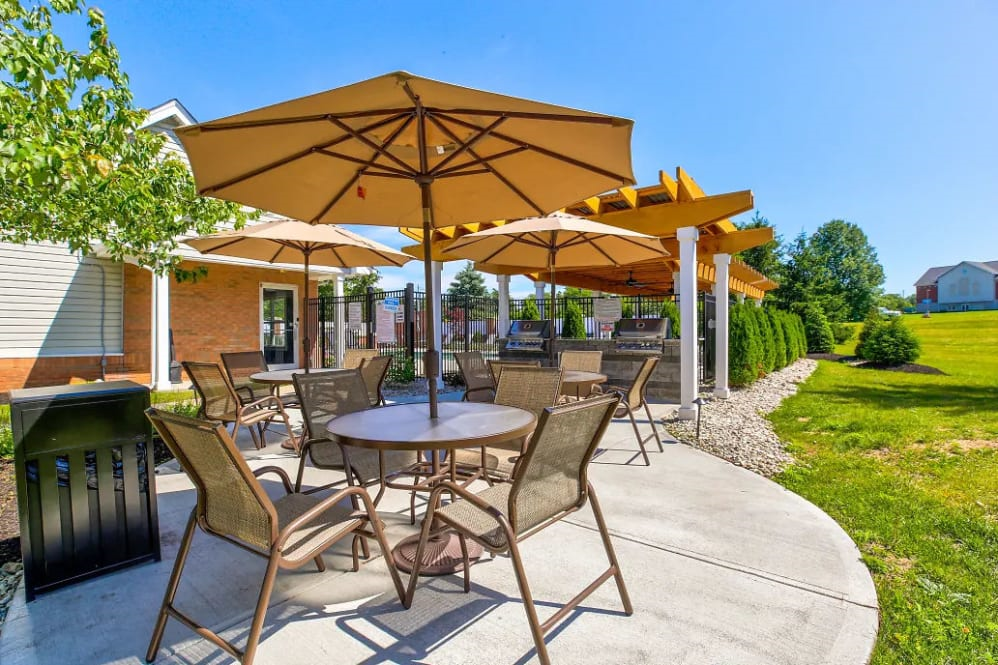 a patio with tables and chairs and umbrellas