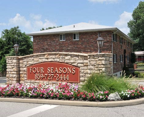 a brick building with a sign on a stone wall