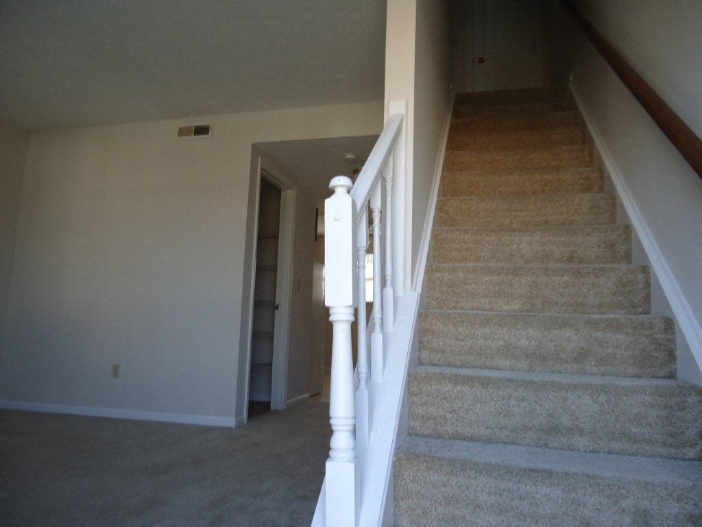 a view of the stairs in a house from the bottom of them