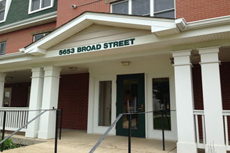 the entrance to 865 broad street in front of a brick building