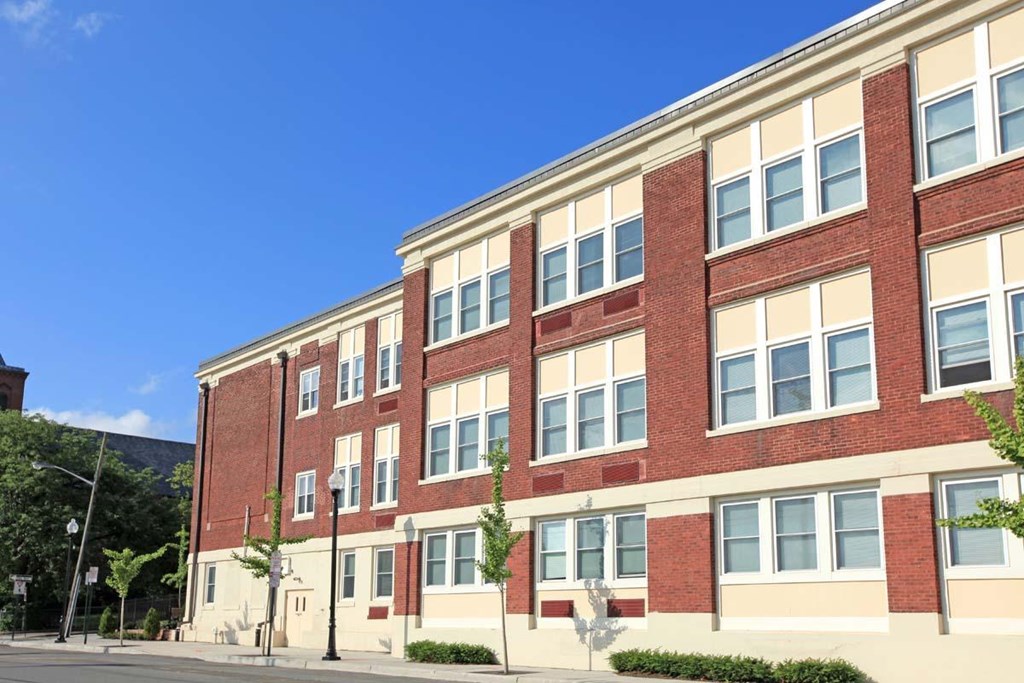 a large brick building with a blue sky in the background