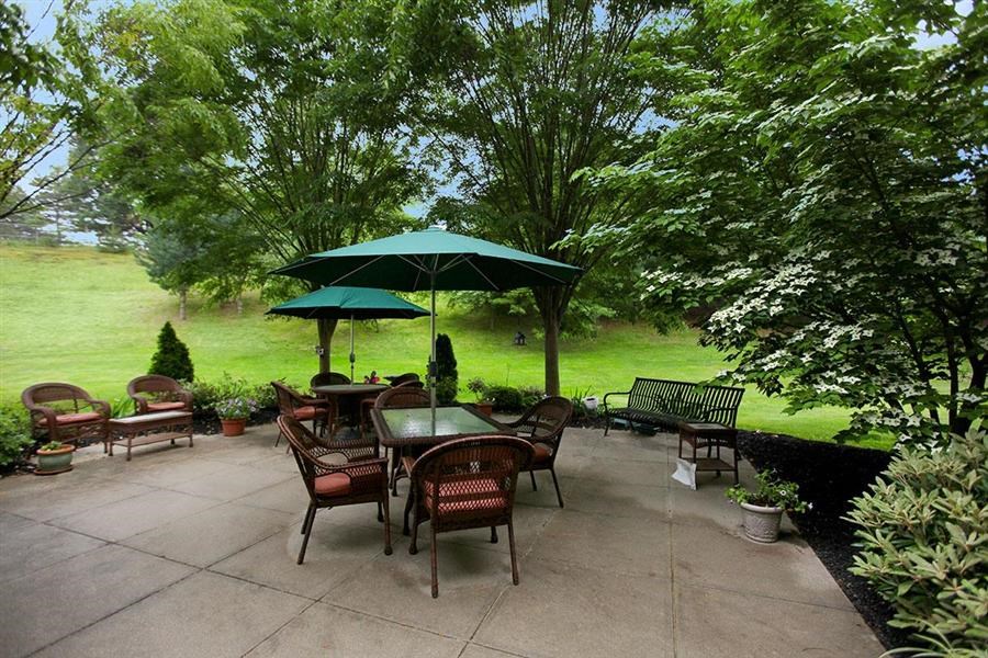 a patio with a table and chairs and a umbrella