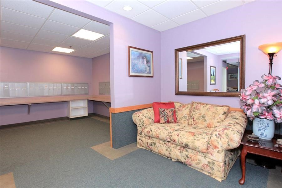 a living room with a couch and a mirror