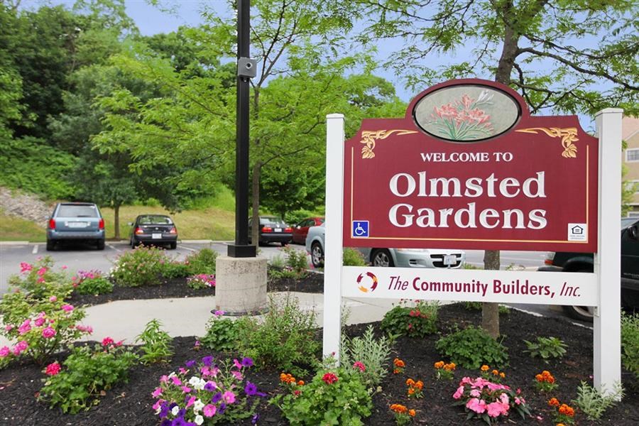 a sign for olmsted gardens at the community builders sign