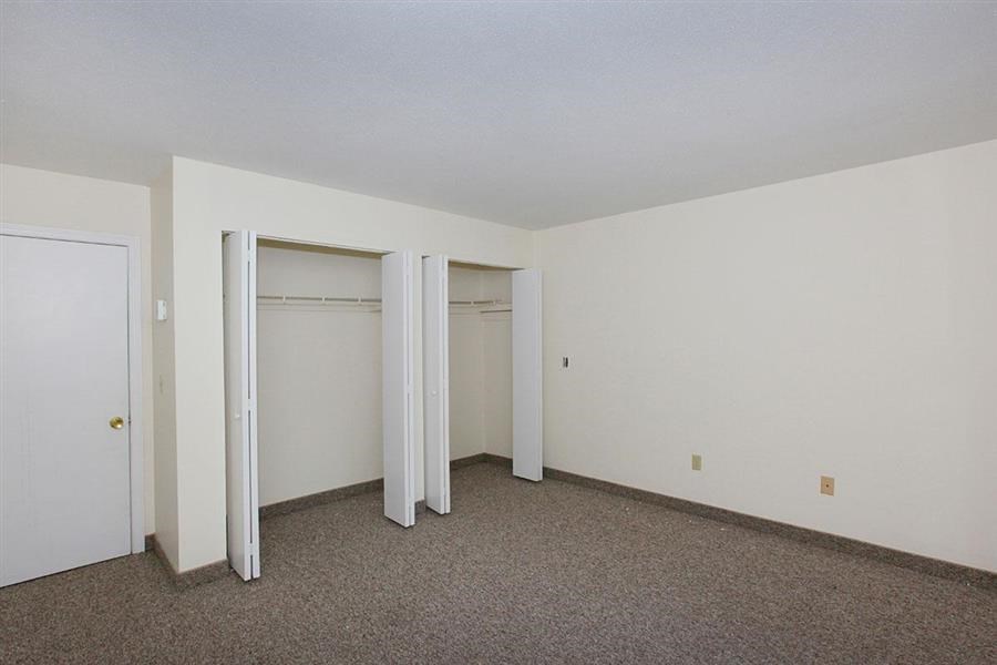 an empty room with three closets in it