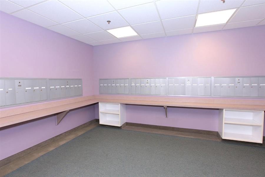 a room with a long desk and lockers in it