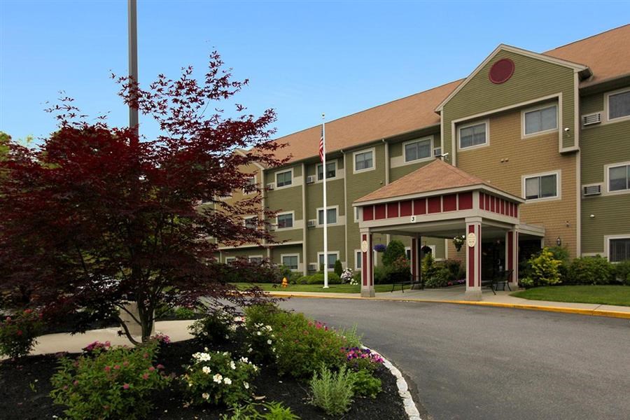 a building with a porch and a street in front of it