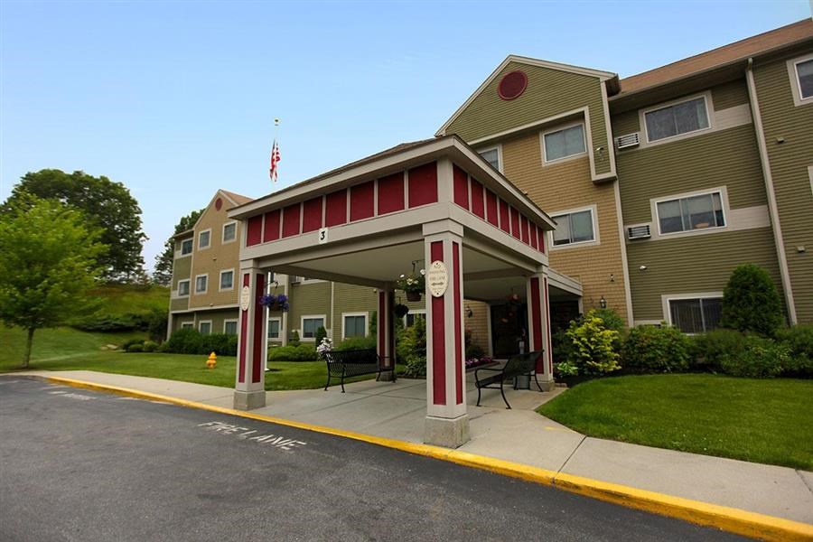 a building with a red and white covered porch
