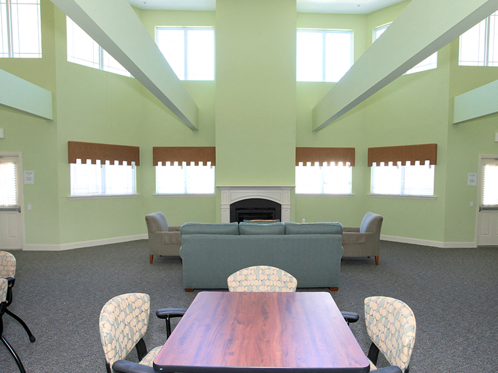 a living room with a table and a fireplace
