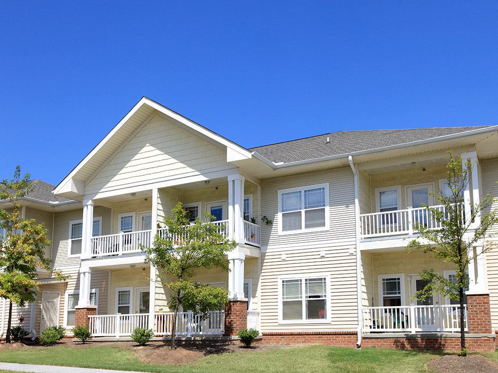 a large white house with a yard in front of it