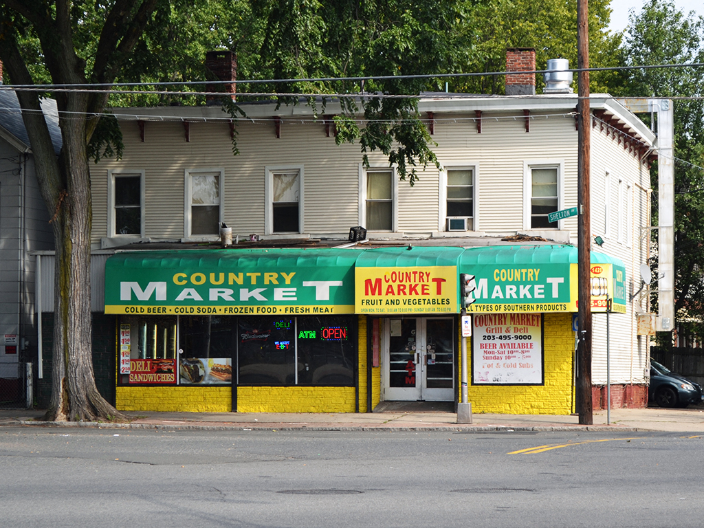 a country market store on the corner of a city street