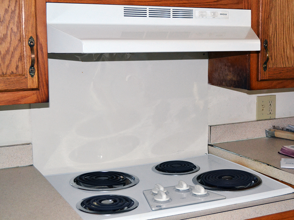 a kitchen with a stove top oven and a microwave
