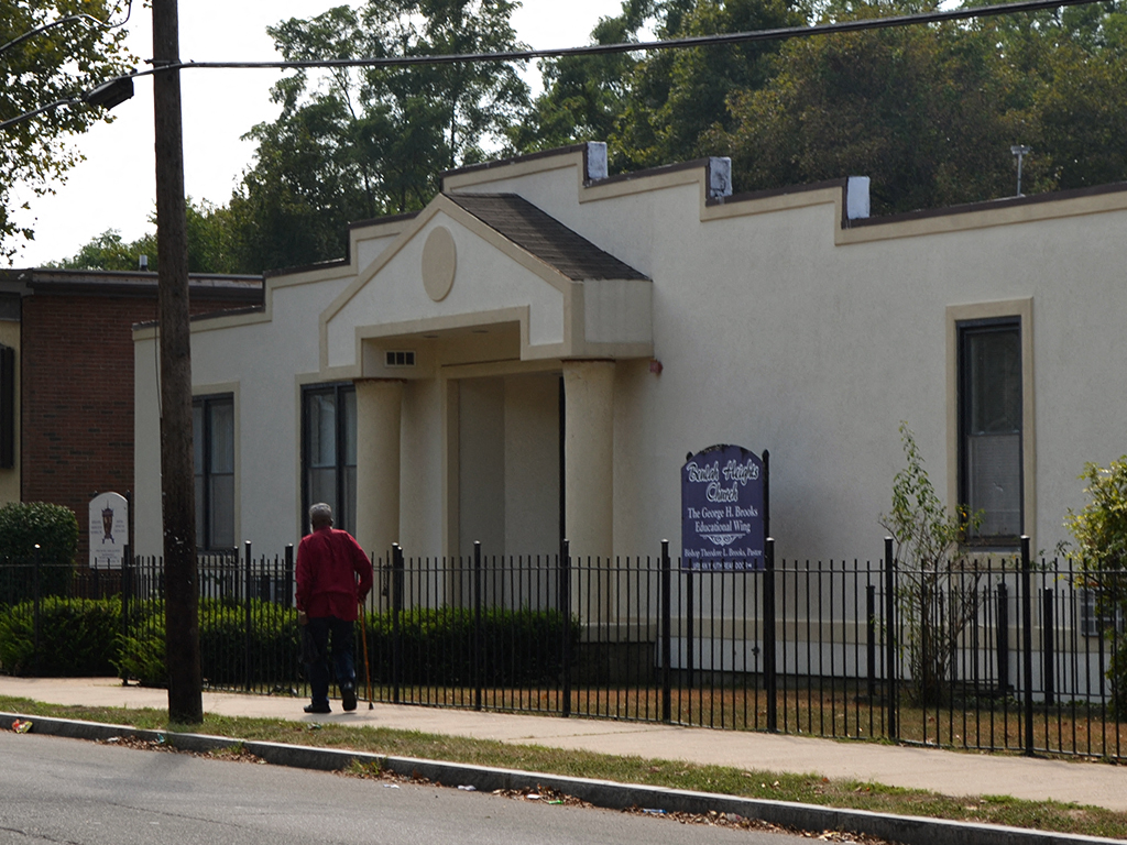 a man standing outside the front of a church building