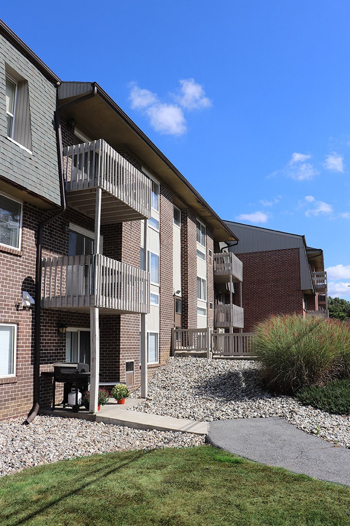 a view of a building with balconies and a sidewalk