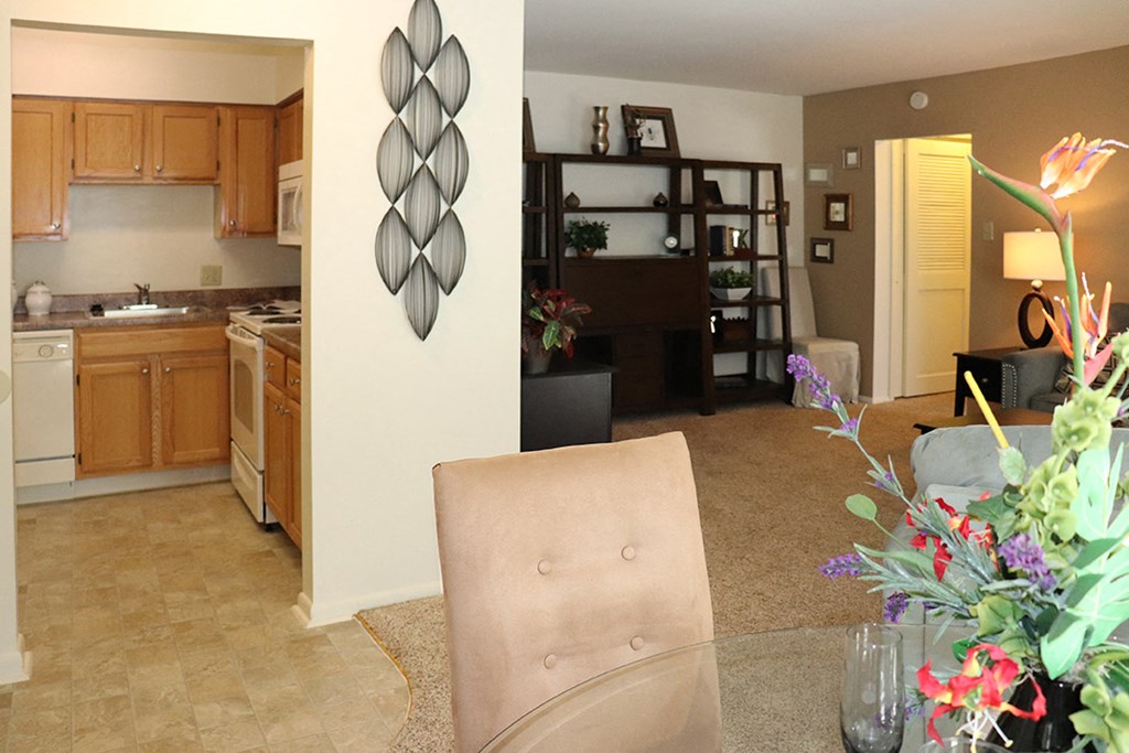 a living room and kitchen with a table and chairs