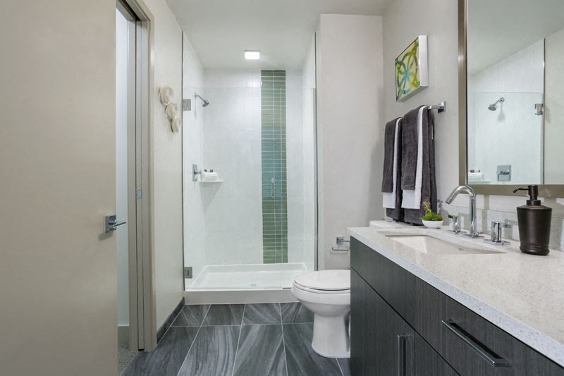 a bathroom with a toilet and a shower and a sink