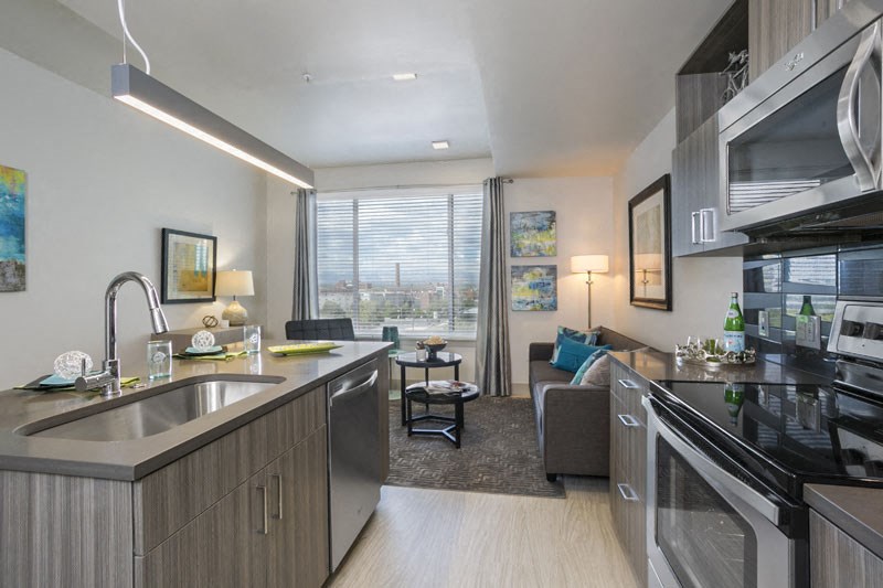 a kitchen and living room of an apartment
