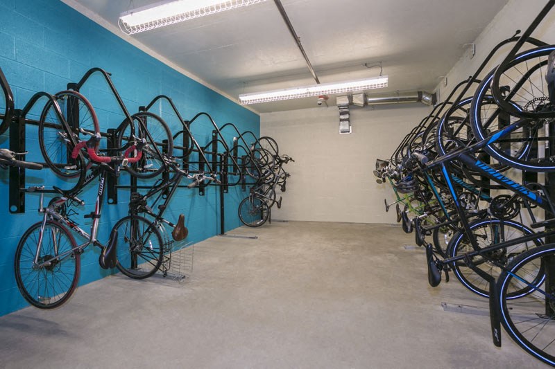the inside of a bike shop with many bikes hanging on the wall