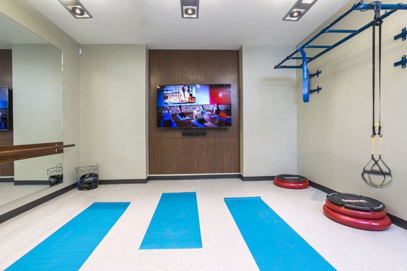 a gym with a tv in the corner of a room