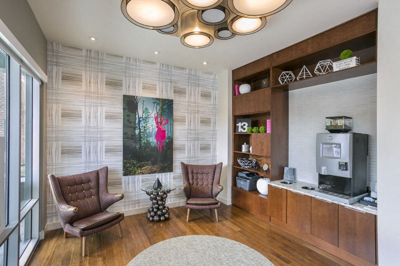 a living room with two chairs and a television