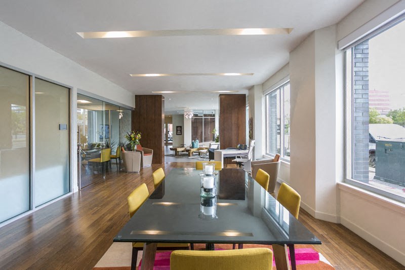 a large dining room with a table and chairs