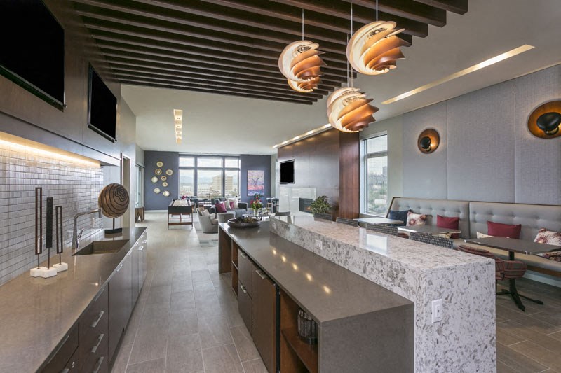 a kitchen with a long counter top and a large window