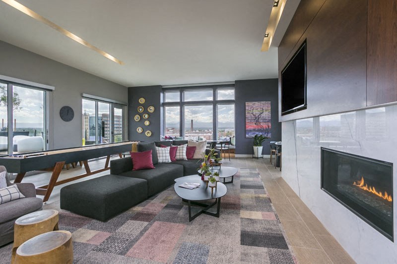 a living room with a fireplace and a couch and a table