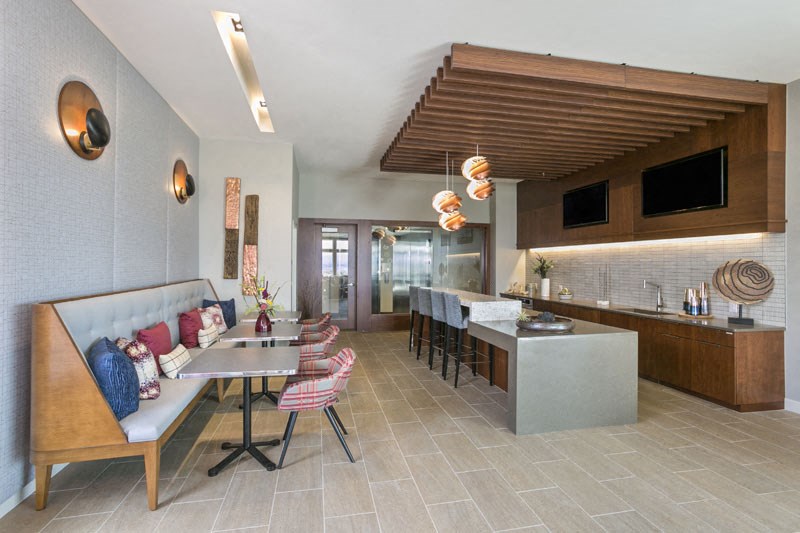a living room and kitchen with a table and chairs