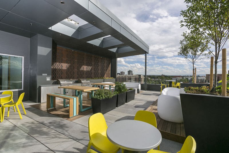 a rendering of a rooftop patio with tables and chairs