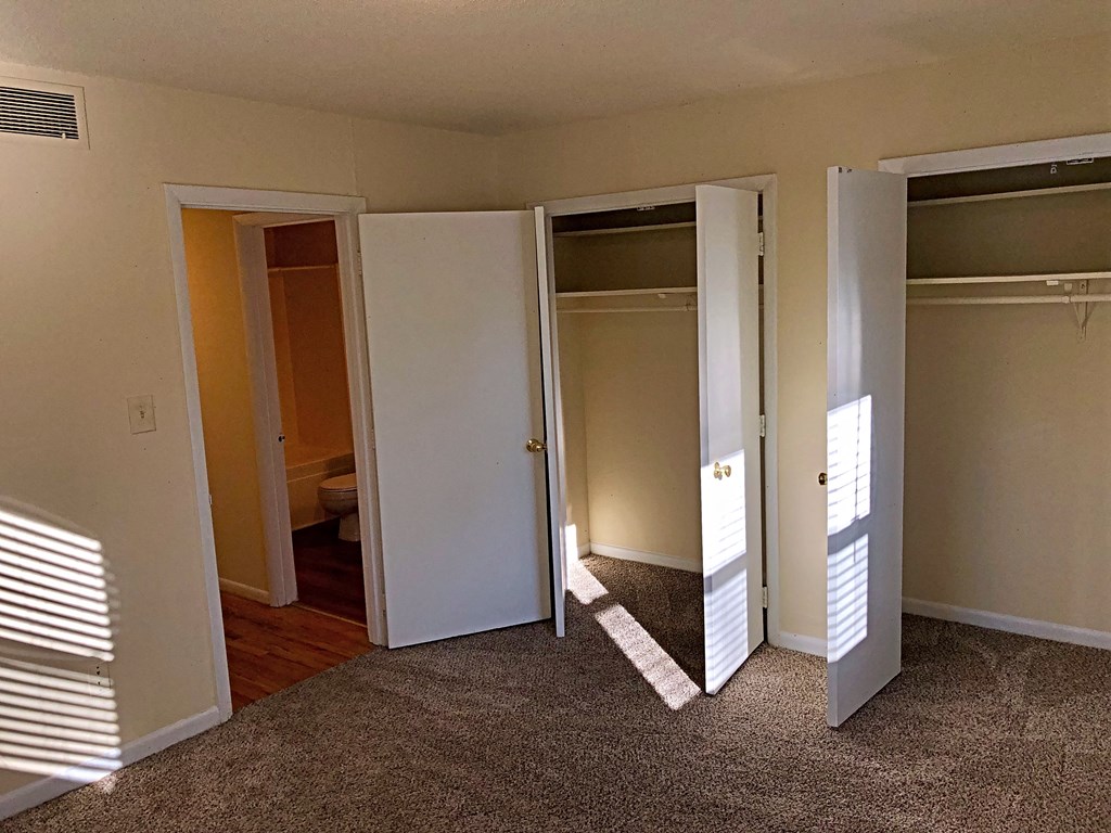 a living room with several closets and doors