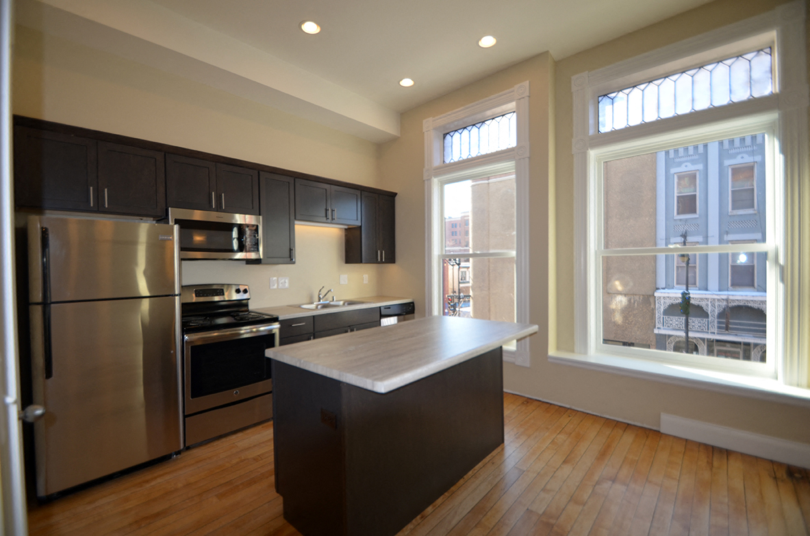 a kitchen with stainless steel appliances and a large window