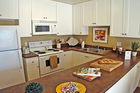 a kitchen with white cabinets and a counter top