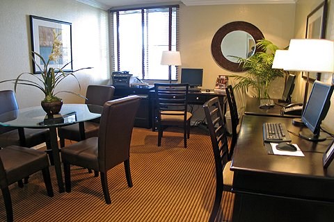 a living room and dining room with a table and chairs
