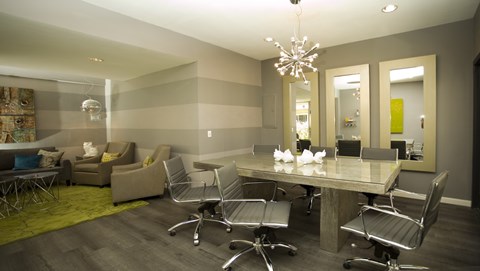 A conference room with a long table and chairs.