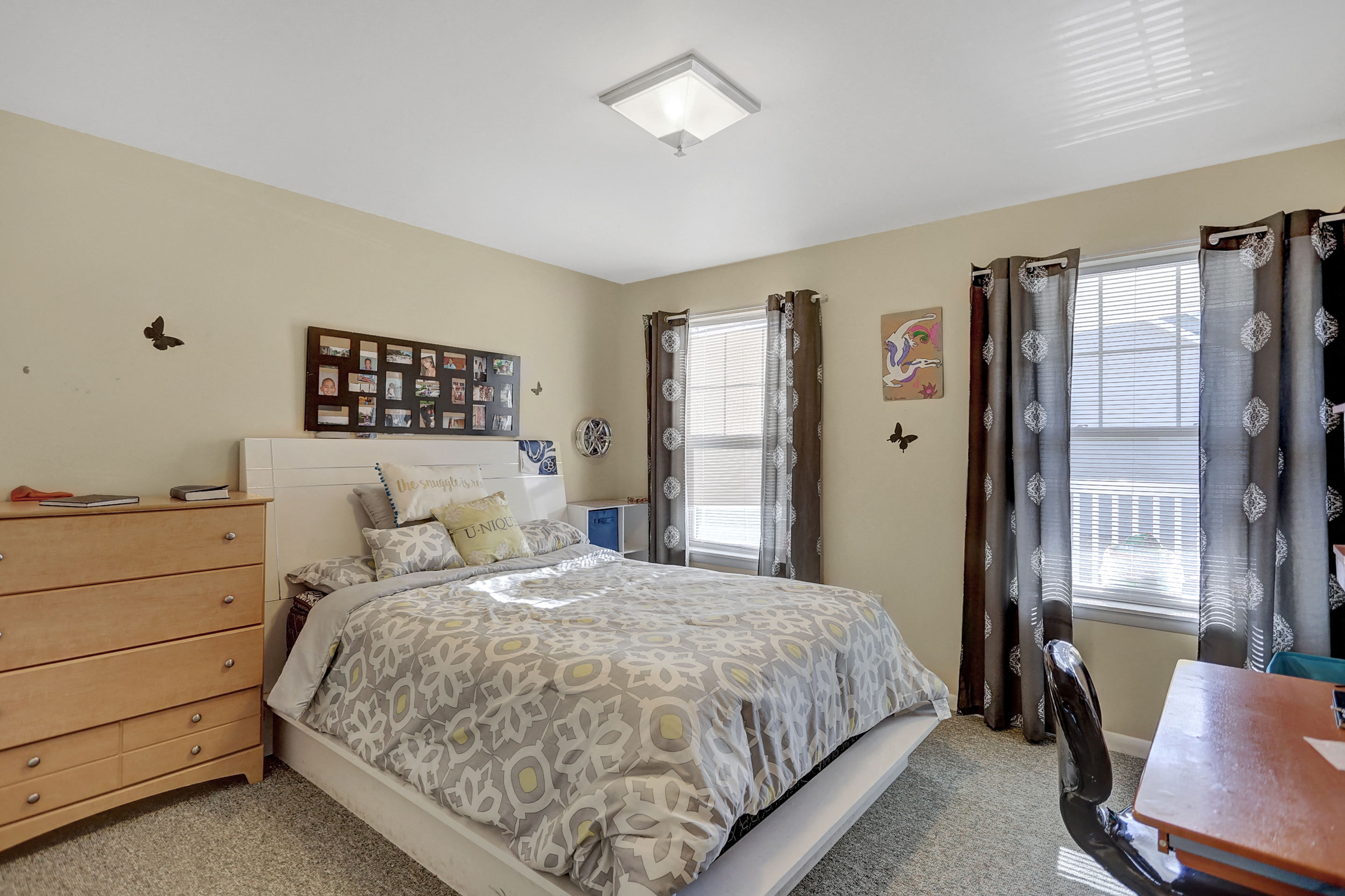 a bedroom with a bed and a dresser and window