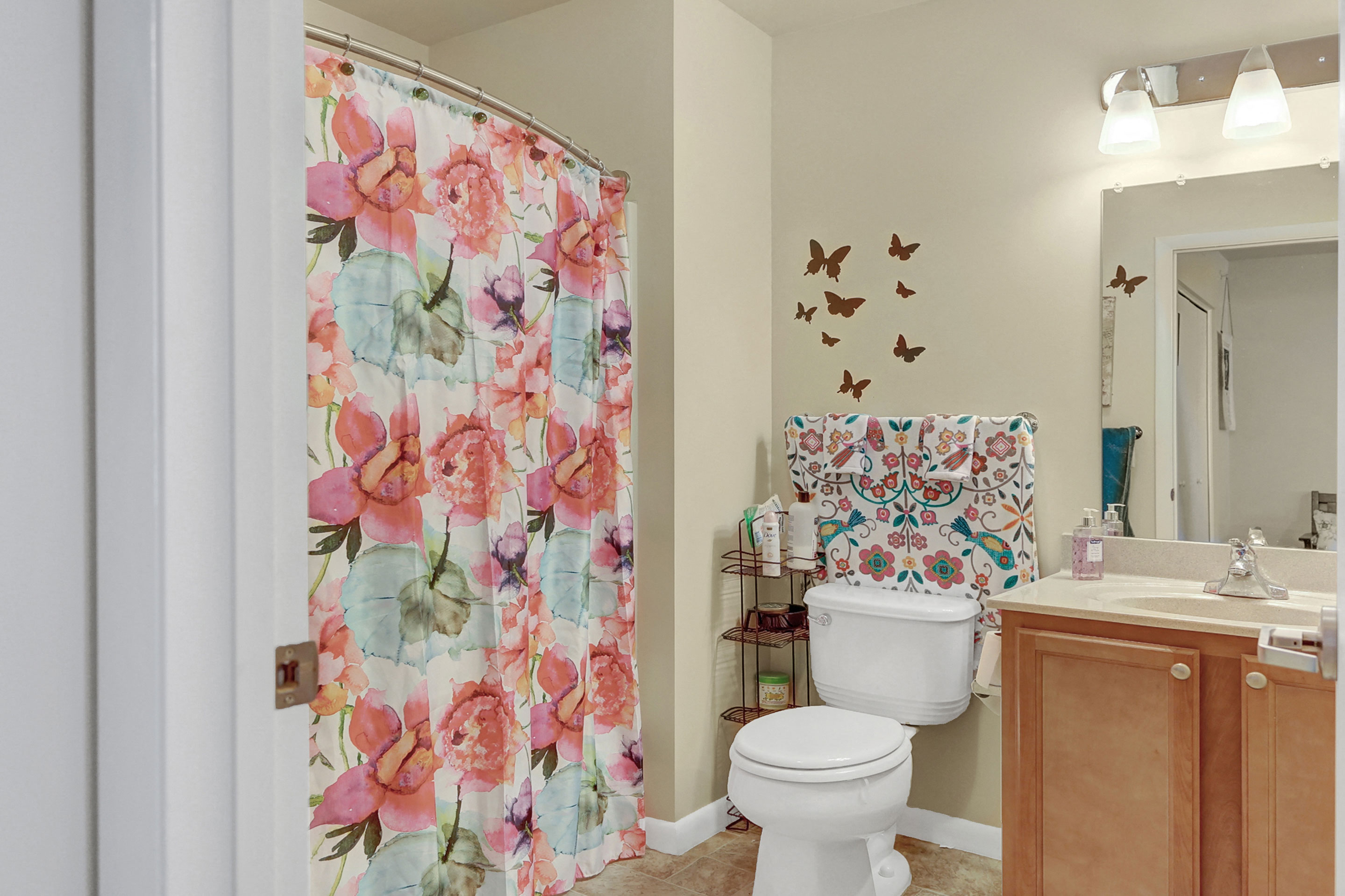 a bathroom with a shower curtain and a toilet