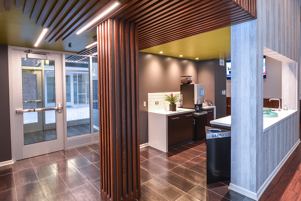 a view of a lobby with a reception desk and an open door