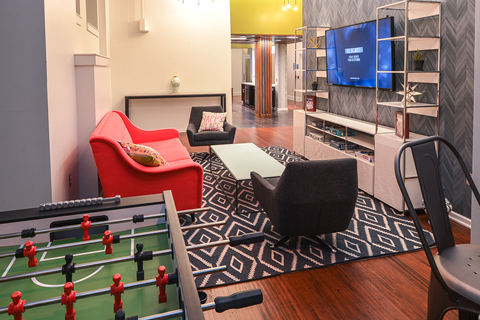 a living room with a pool table and a television