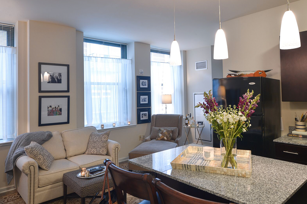 a living room with a couch and a table with flowers