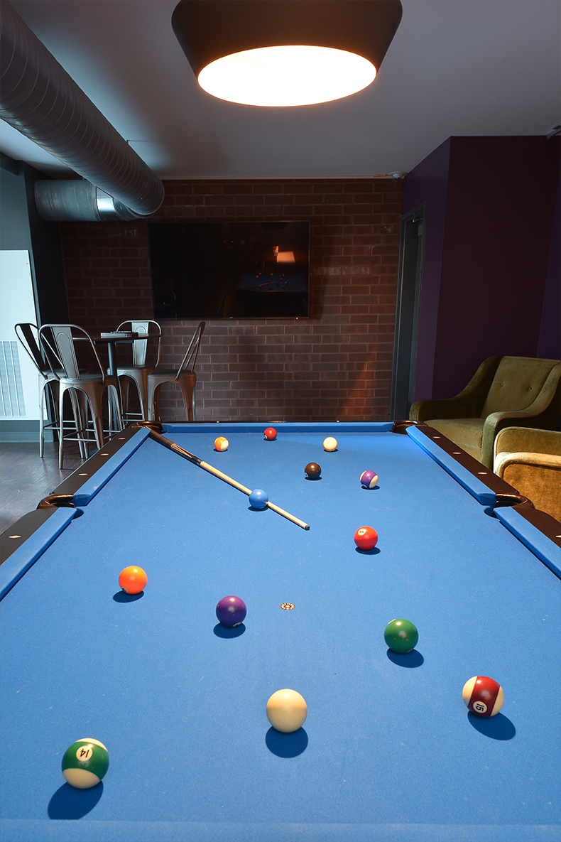 a pool table with balls on it in a room