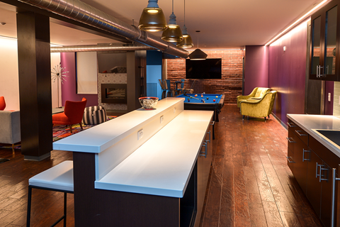 a kitchen with a long island and a pool table