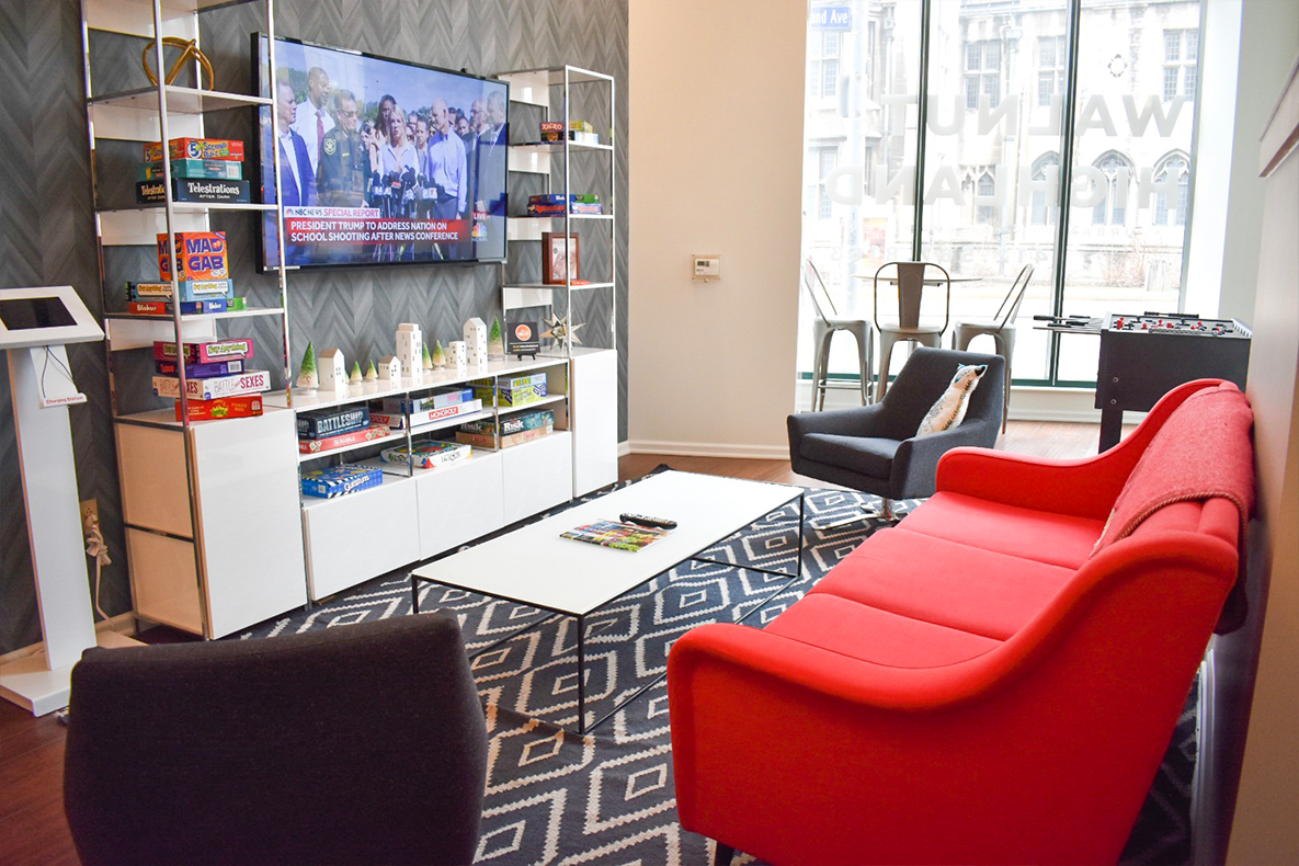 a living room with a red couch and a television